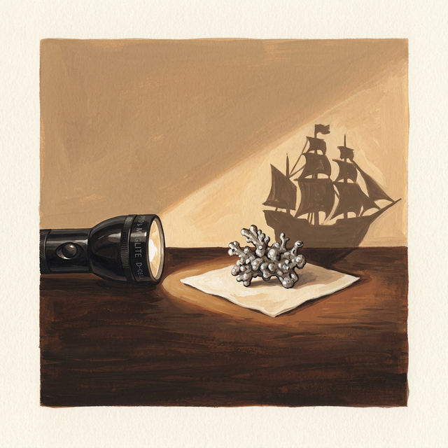 A small twisted piece of cooled lead on a paper towel casting a large ship-shaped shadow on the wall from a flashlight beam